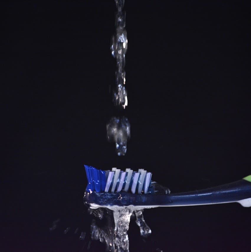 Wet the toothbrush bristles